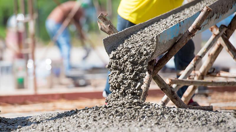 Close-up of pouring concrete from a mixer