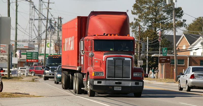 Large truck traveling in busy community