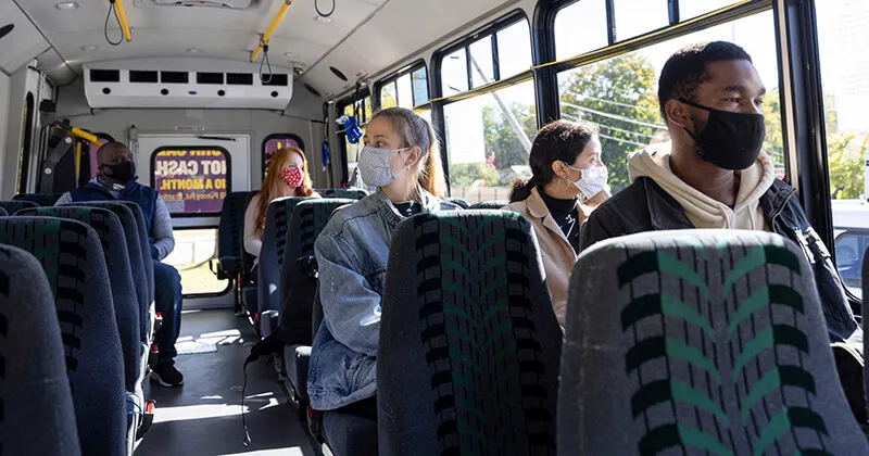 Masked riders on a transit bus during COVID