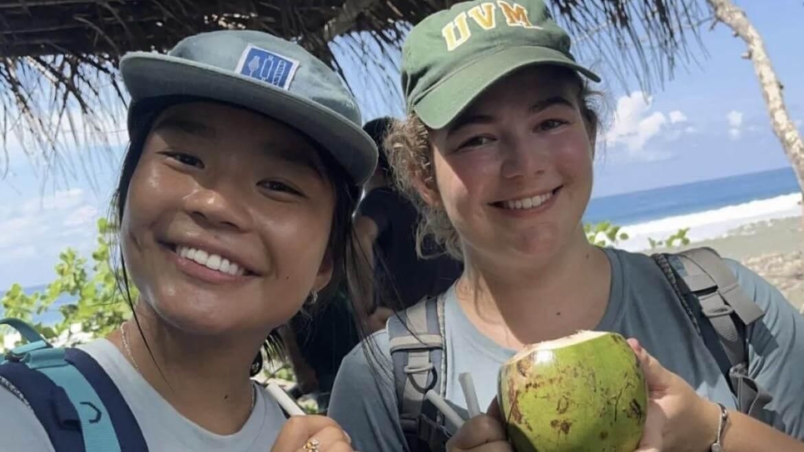 A selfie of Juliana and a friend holding coconuts in Costa Rica.