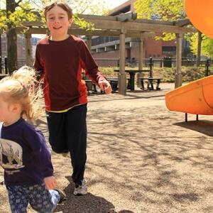 Kids running around in outdoor playing ground