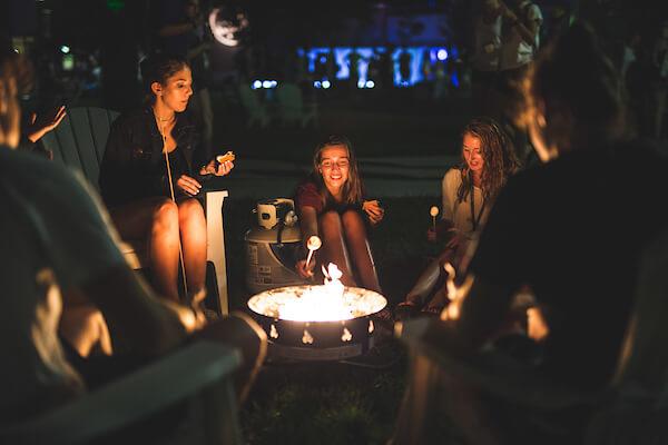 Students making smores around a campfire