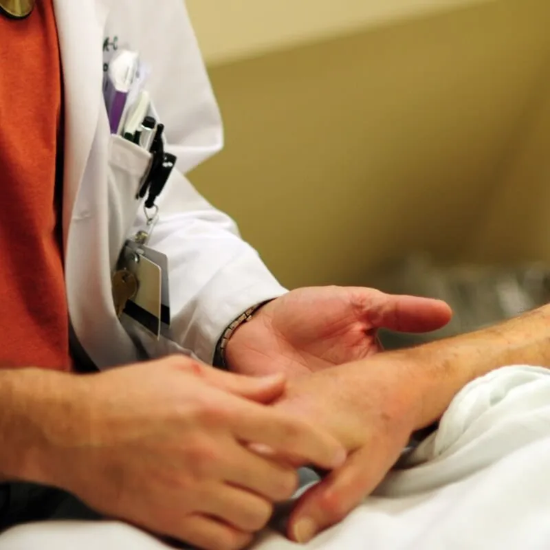 doctor holding hand of a patient
