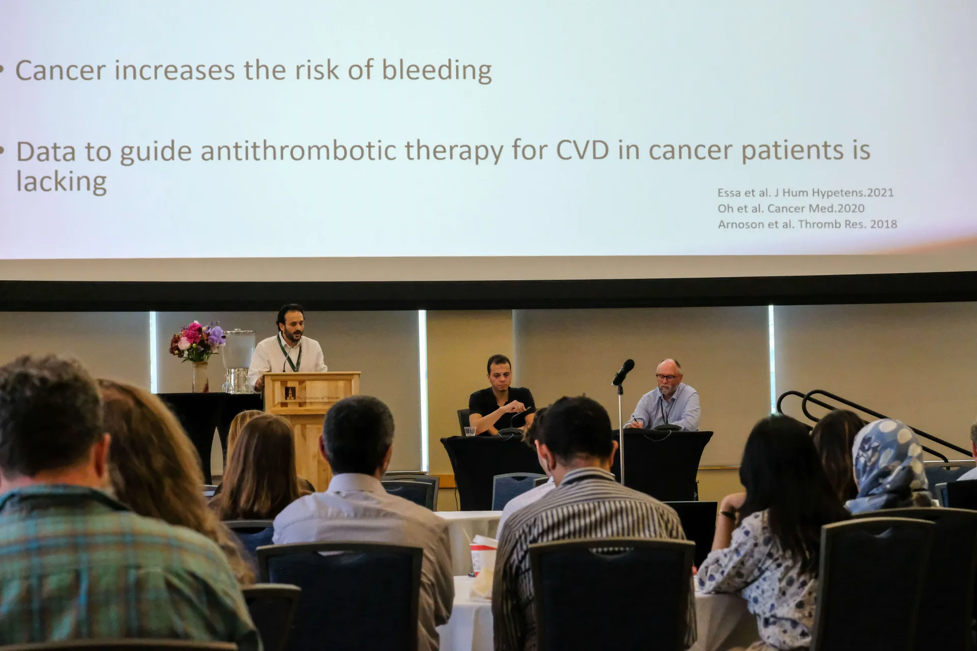 A person giving a lecture in front of a crowd