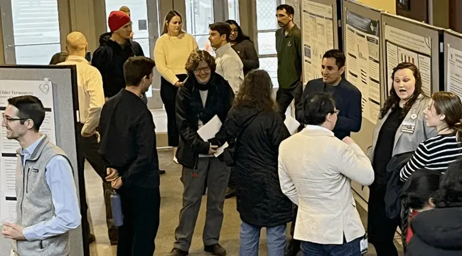 a group of people at a poster session