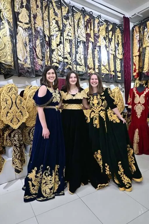 Students try on traditional dresses