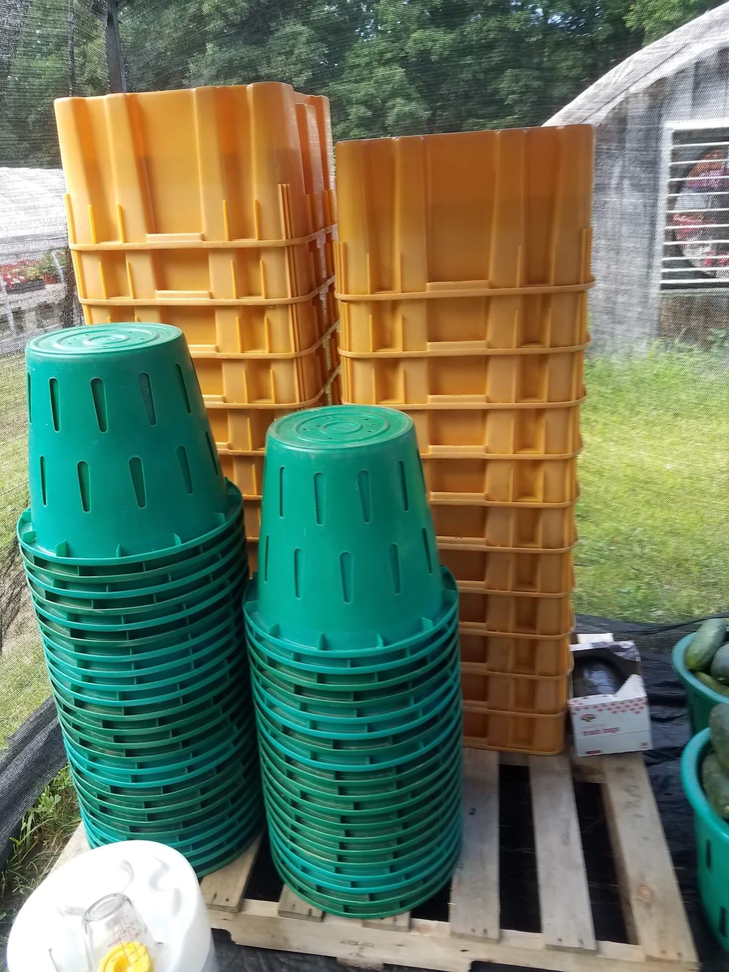stacked plastic bins on a wooden pallet