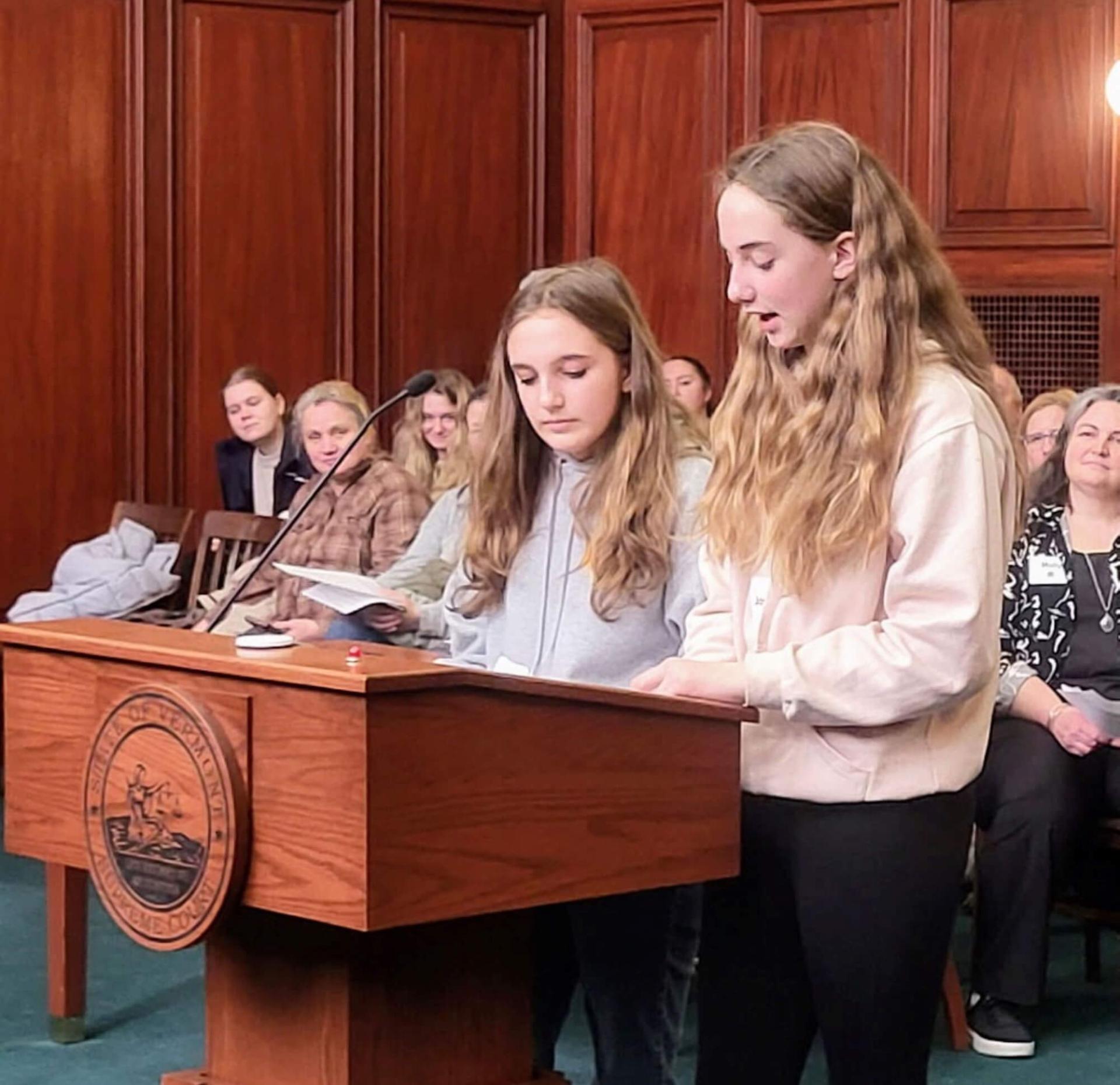 two youths at a podium