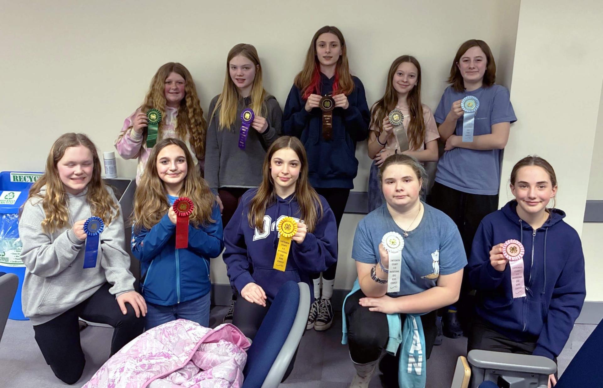 10 kids holding ribbons