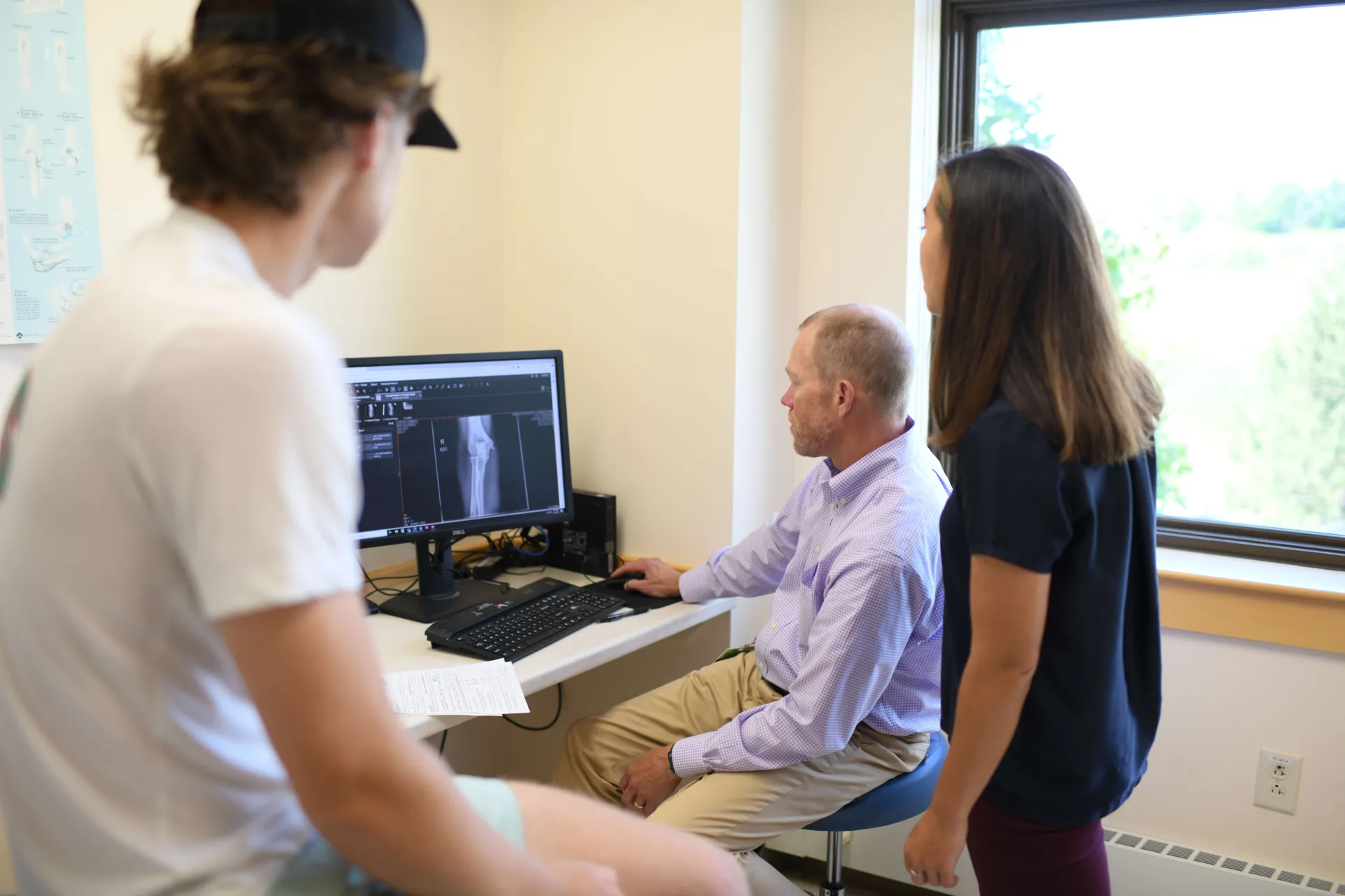 Patient and provider looking at imaging of joint