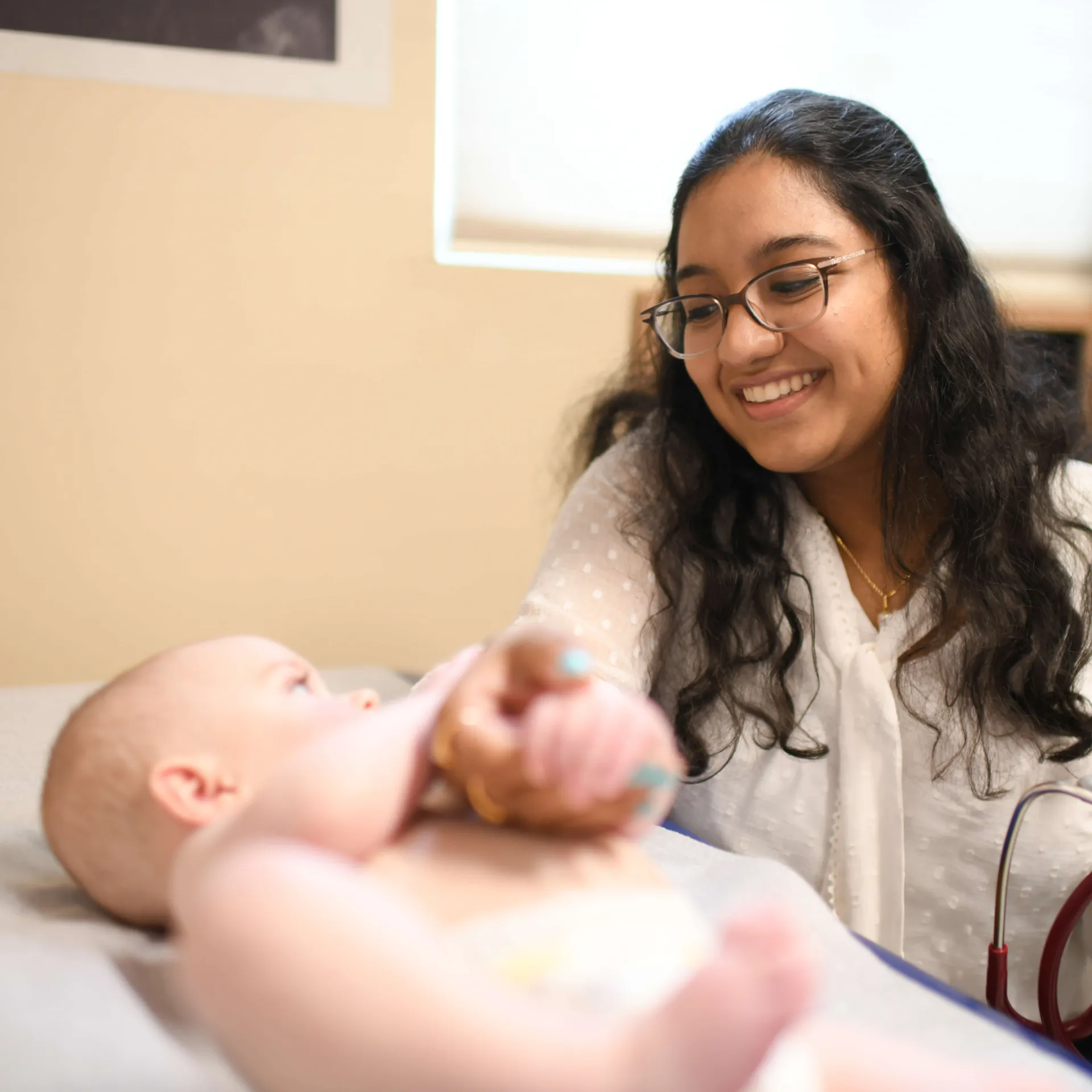 Provider playing with infant patient