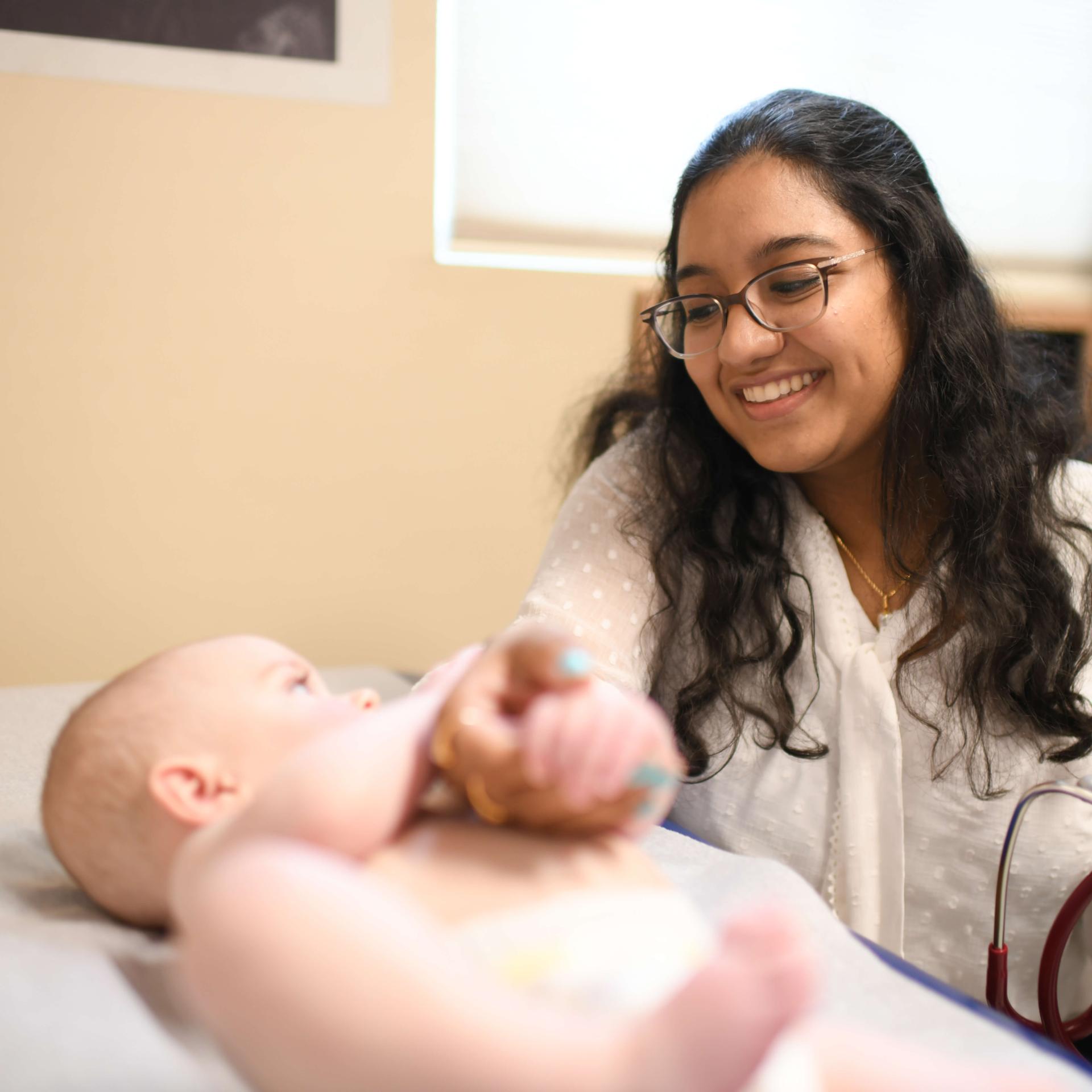 Provider playing with infant patient