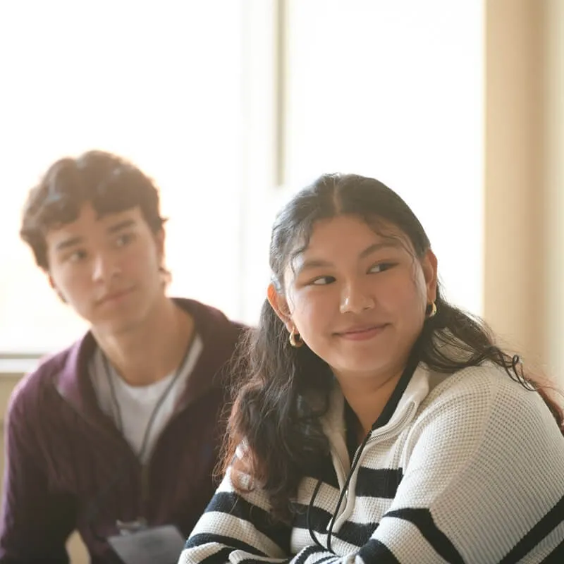 two young people listening attentively