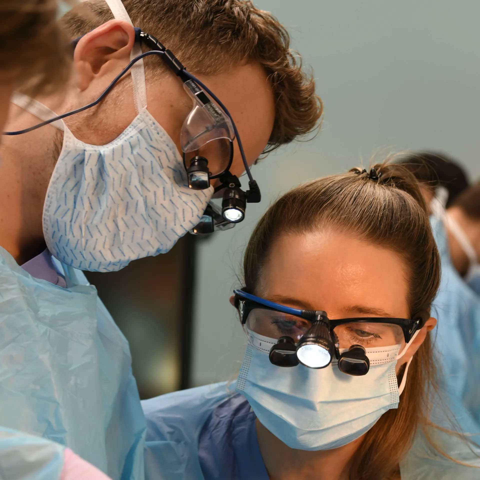 This is a photo from a surgical lab, but the people look like they could be dentists/dental assistance