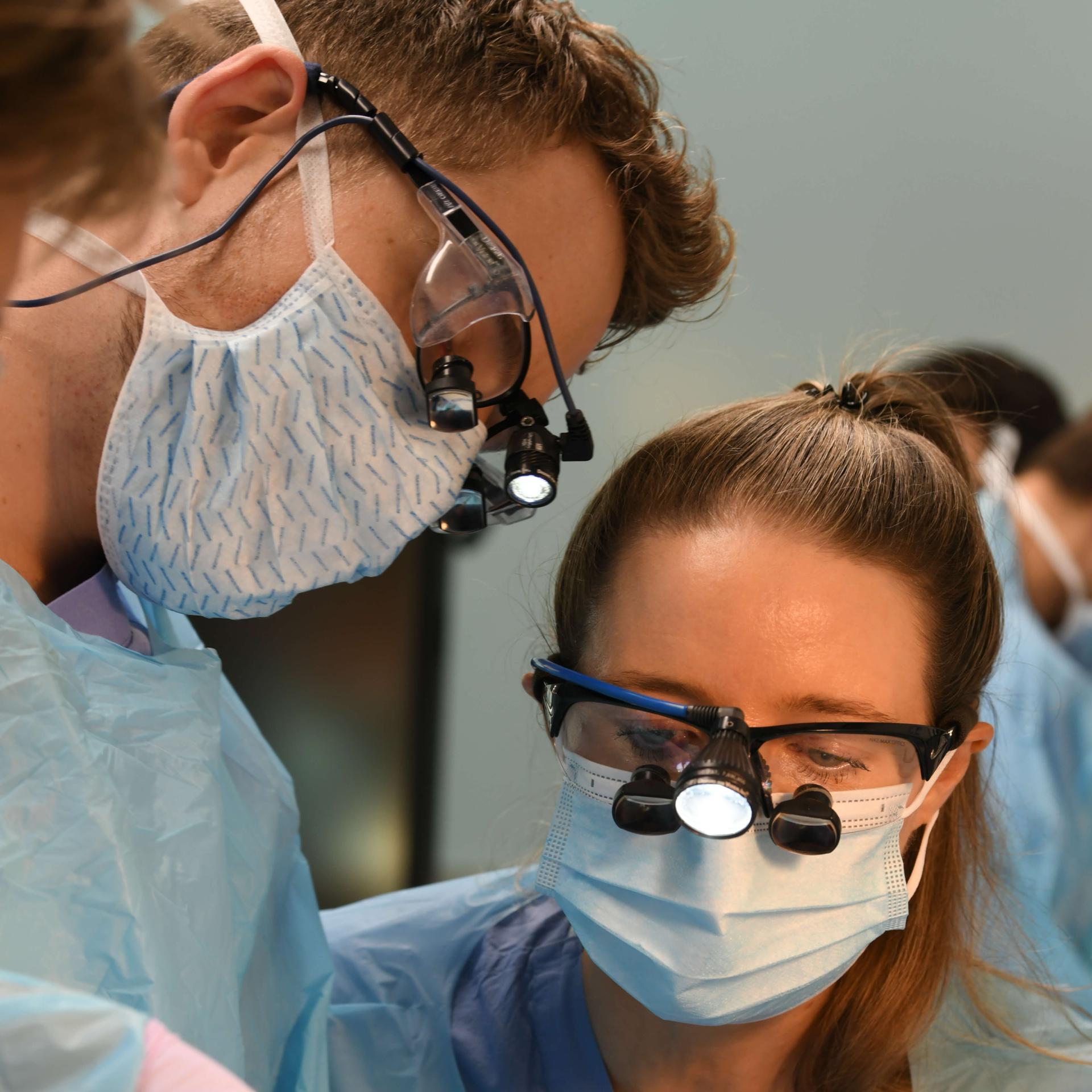 This is a photo from a surgical lab, but the people look like they could be dentists/dental assistance