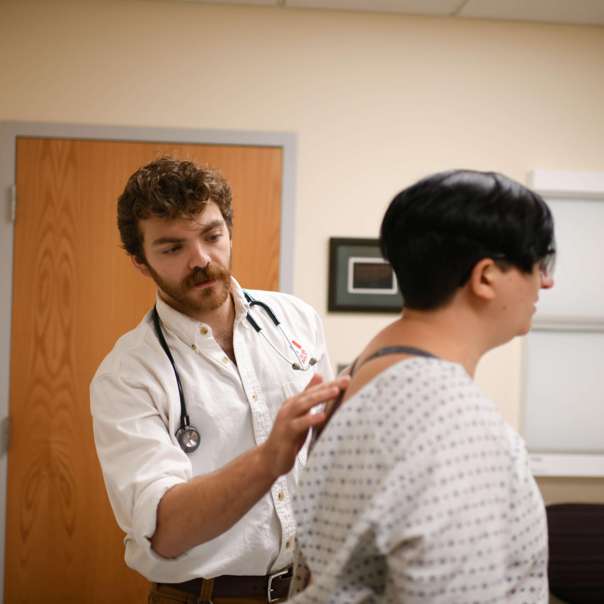 Provider checking patients spine