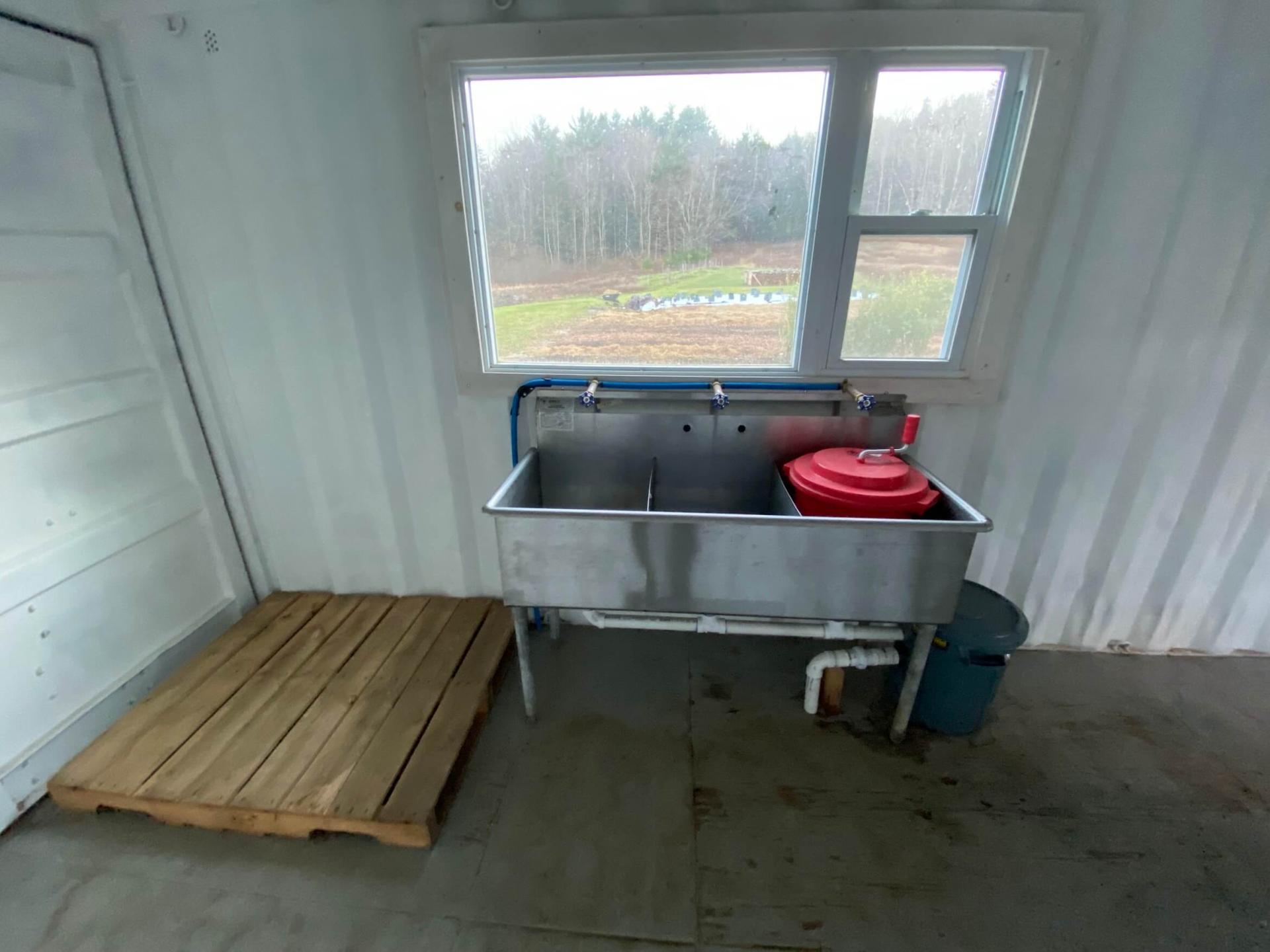 wooden pallet next to a large metal sink