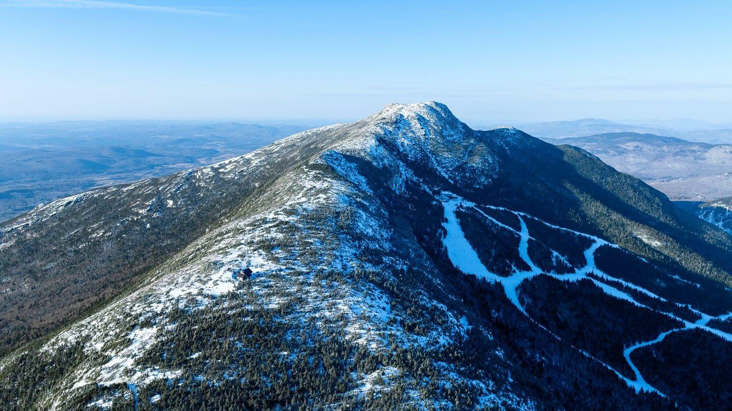 An aerial view of Mount Mansfield in the winter with ski trails in view
