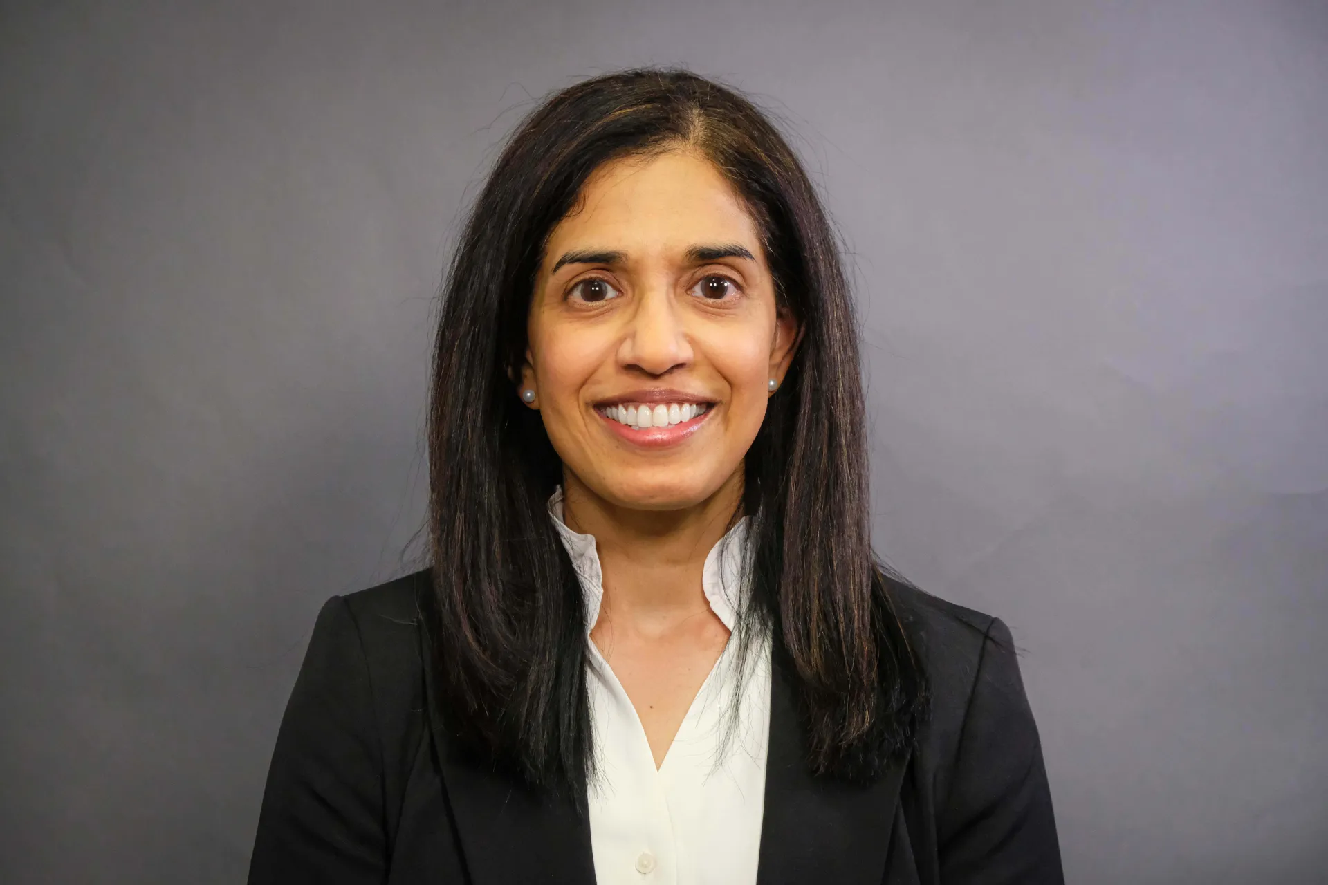 Dr. Nair smiling at the camera