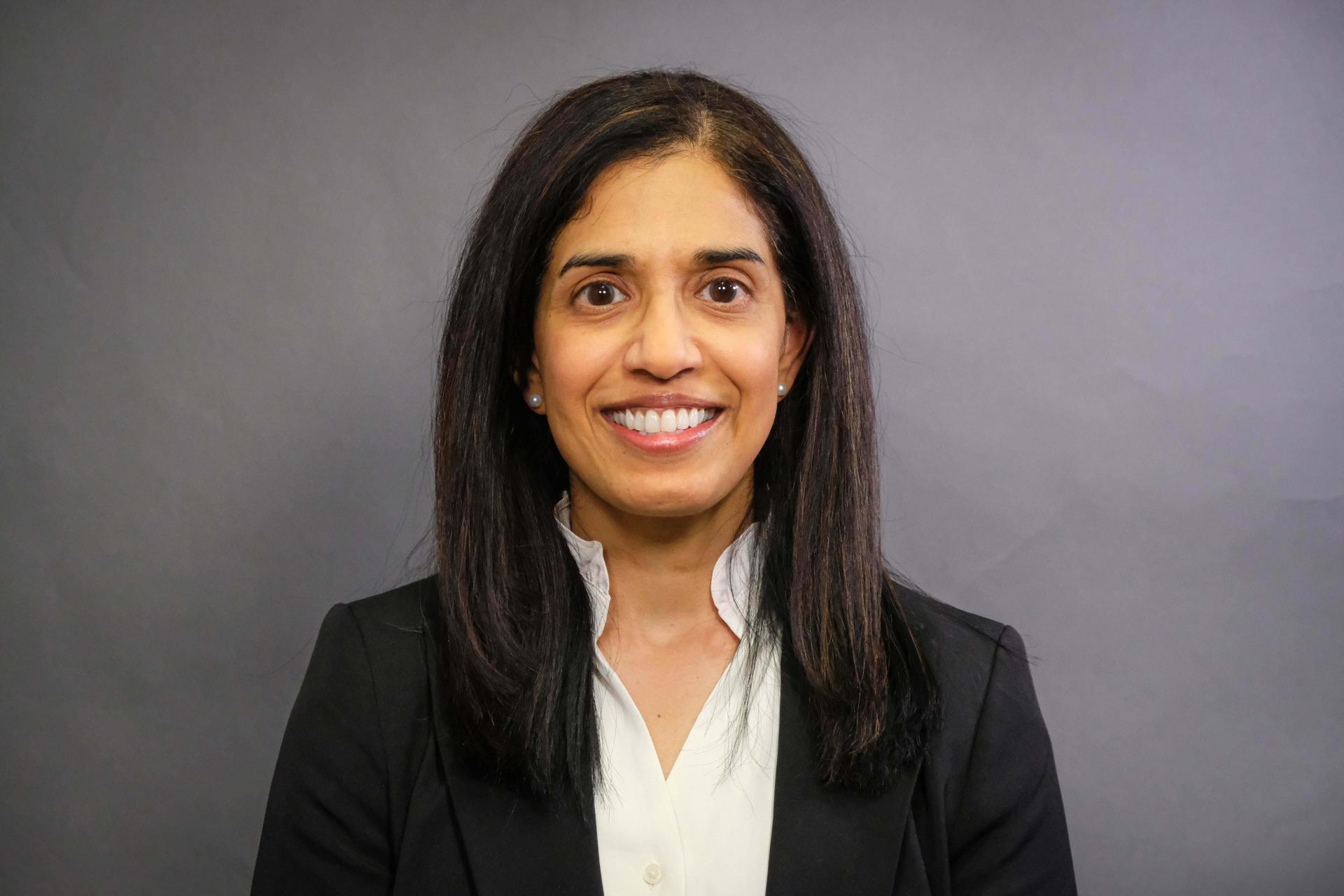 Dr. Nair smiling at the camera