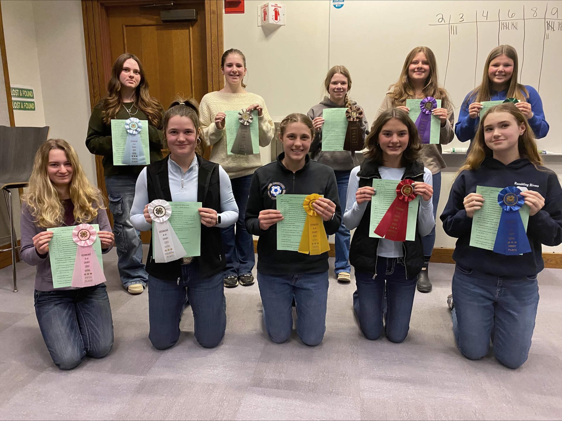 4-H'ers displaying ribbons