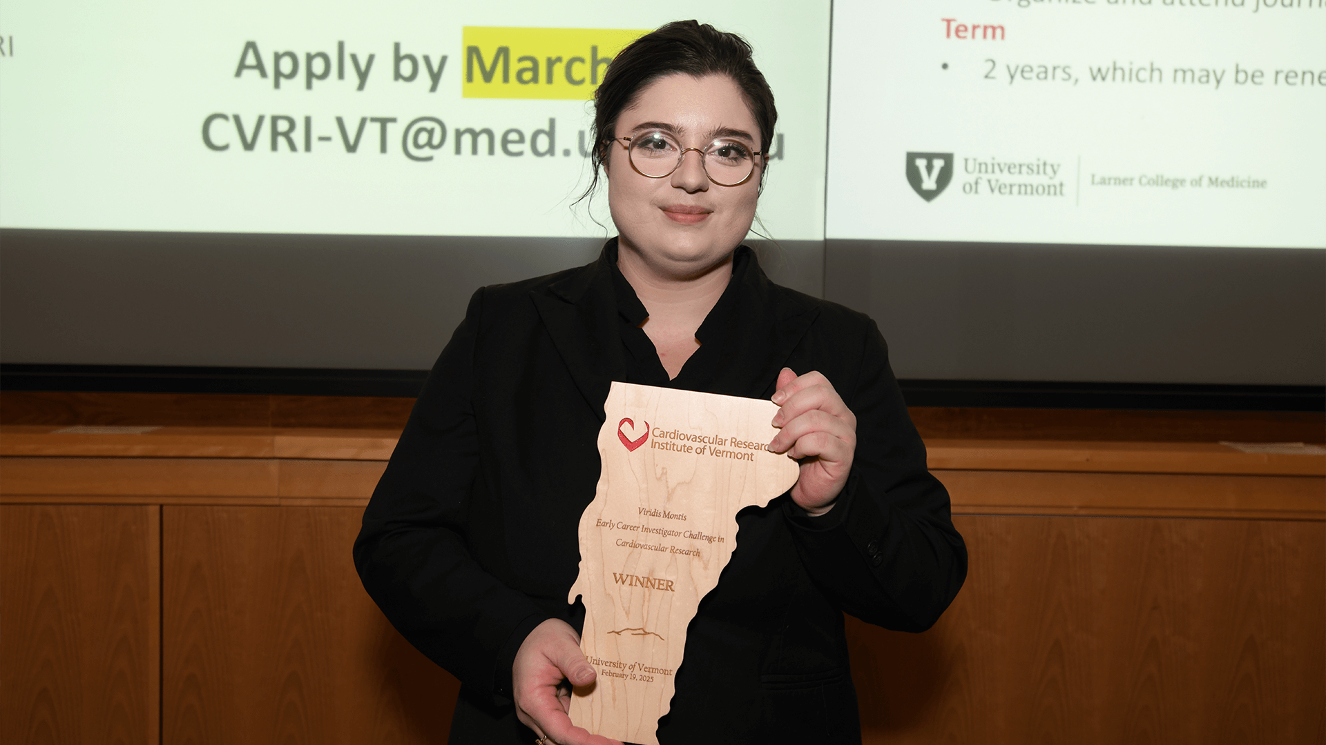 a person holding an award plaque