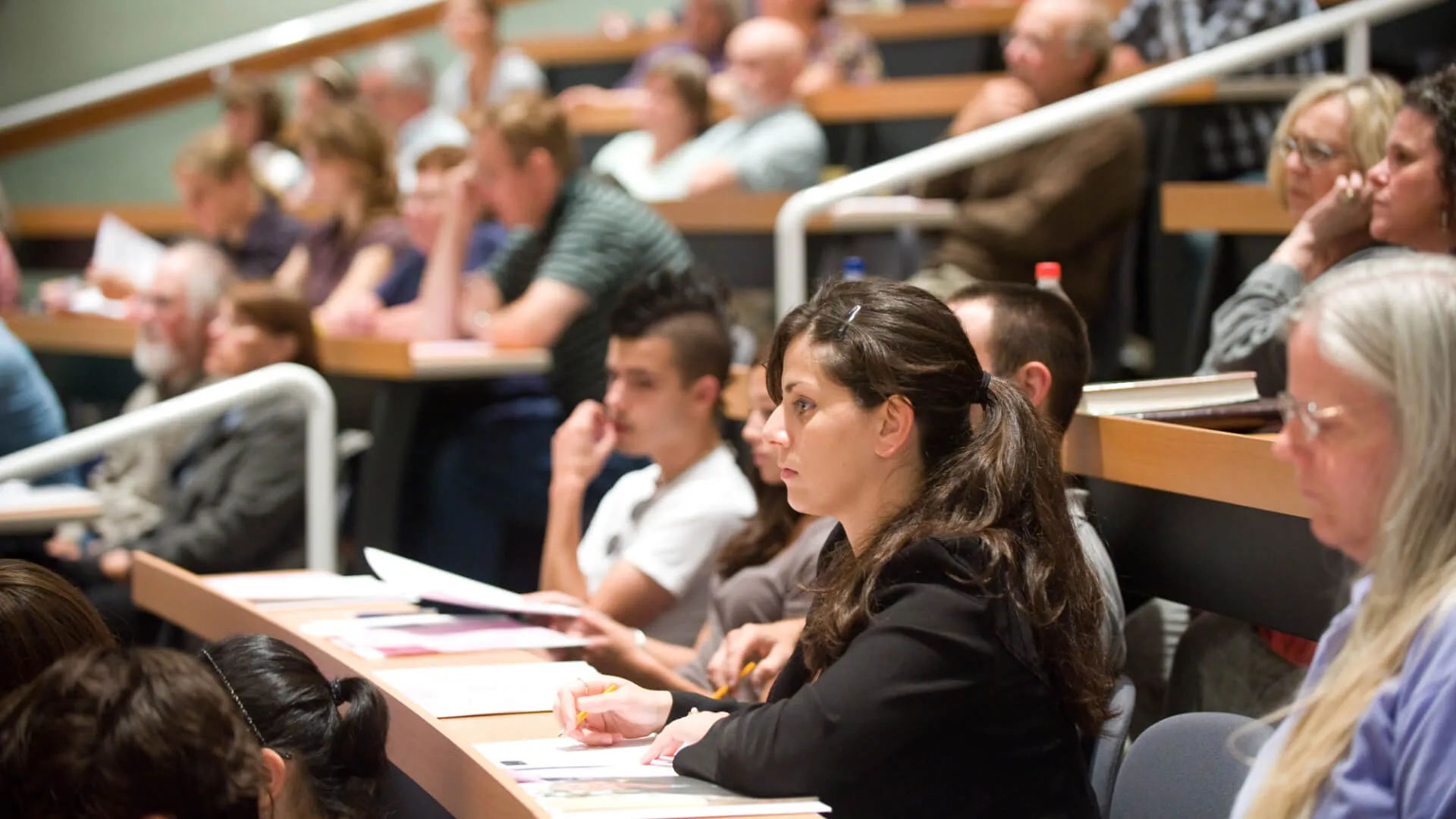 lecture hall full of students and community members.