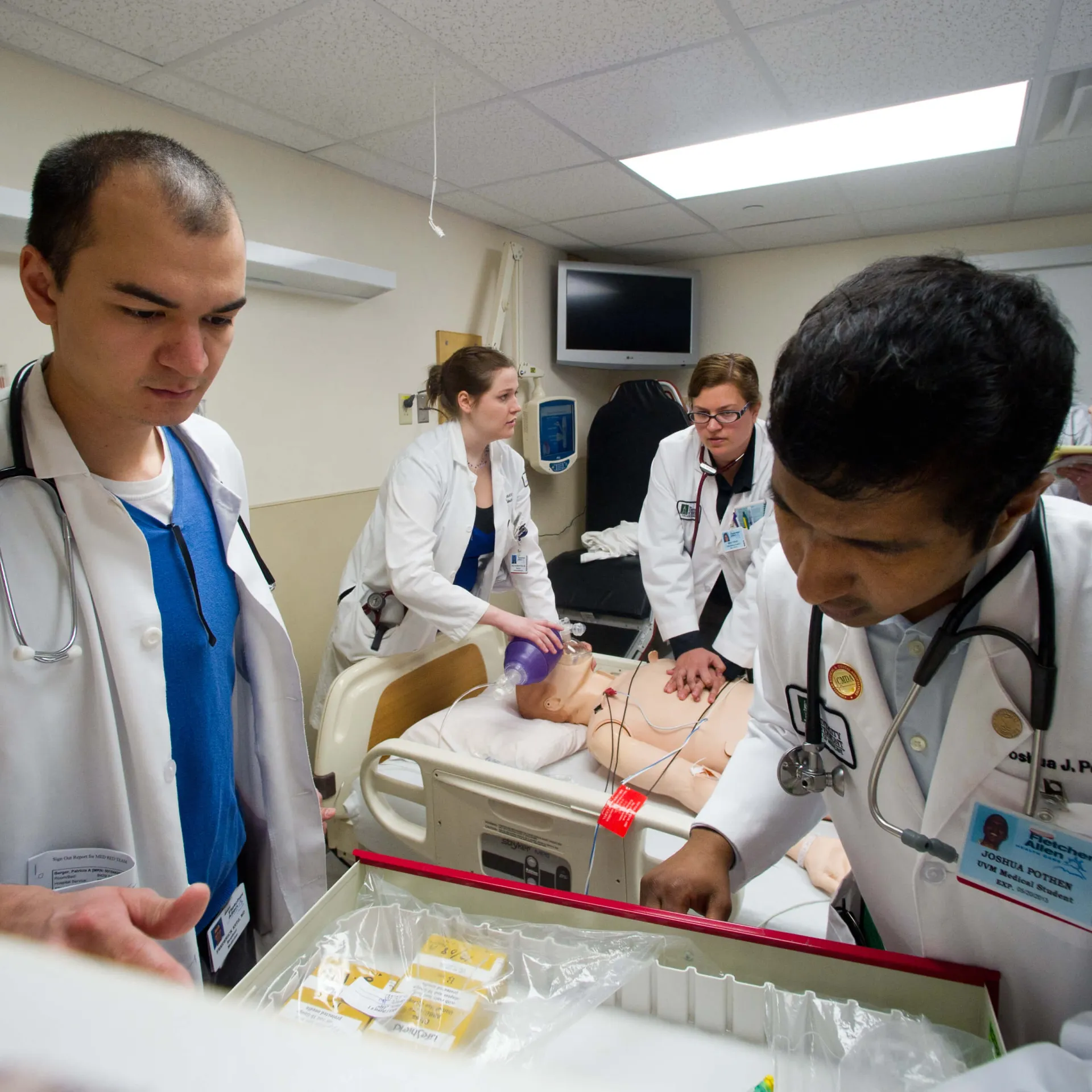 Providers practicing a care simulation on a dummy