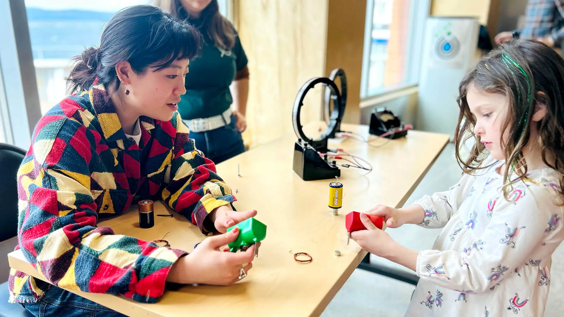 CEMS Physics student shares activities with young visitor