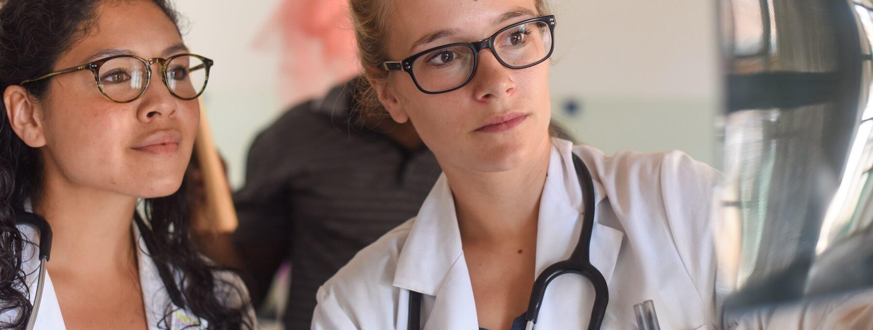 Clinicians looking at radiologic imaging