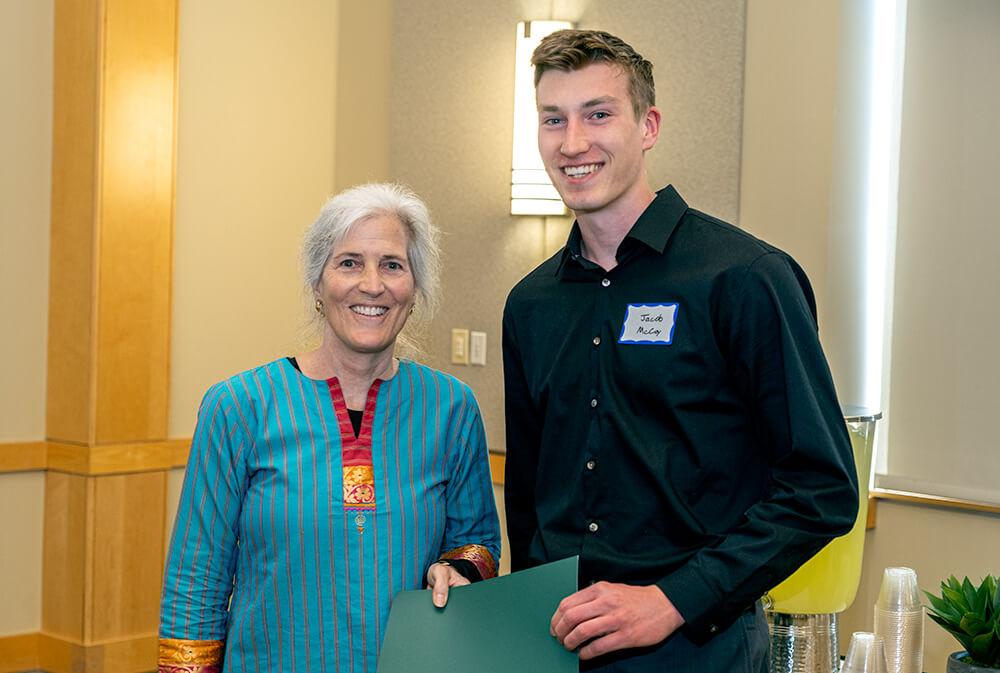 Department of Civil and Environmental Engineering Acting Chair Donna Rizzo presents senior Jacob McCoy with the Edward H. Phelps Prize