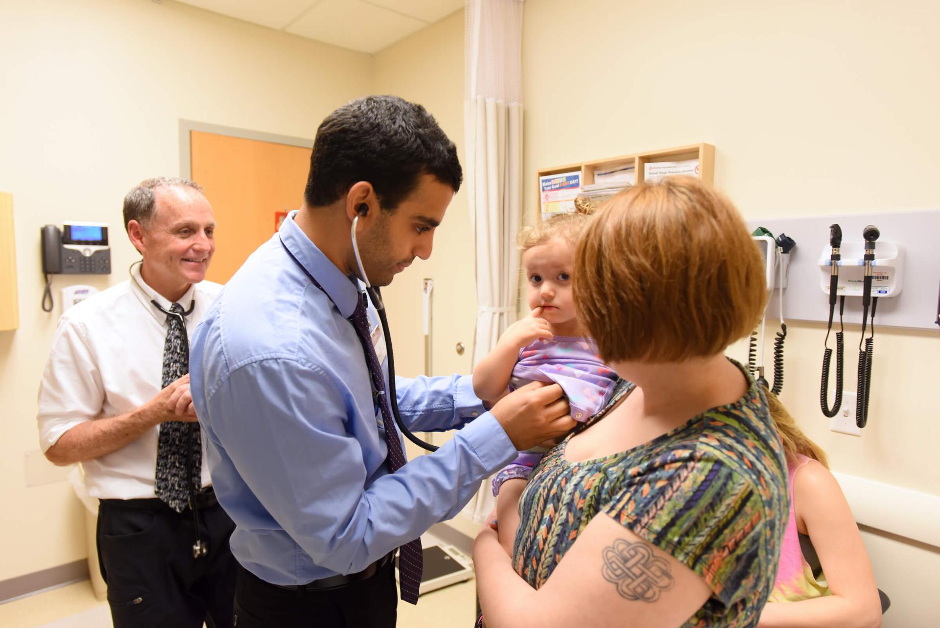 physician examining child patient