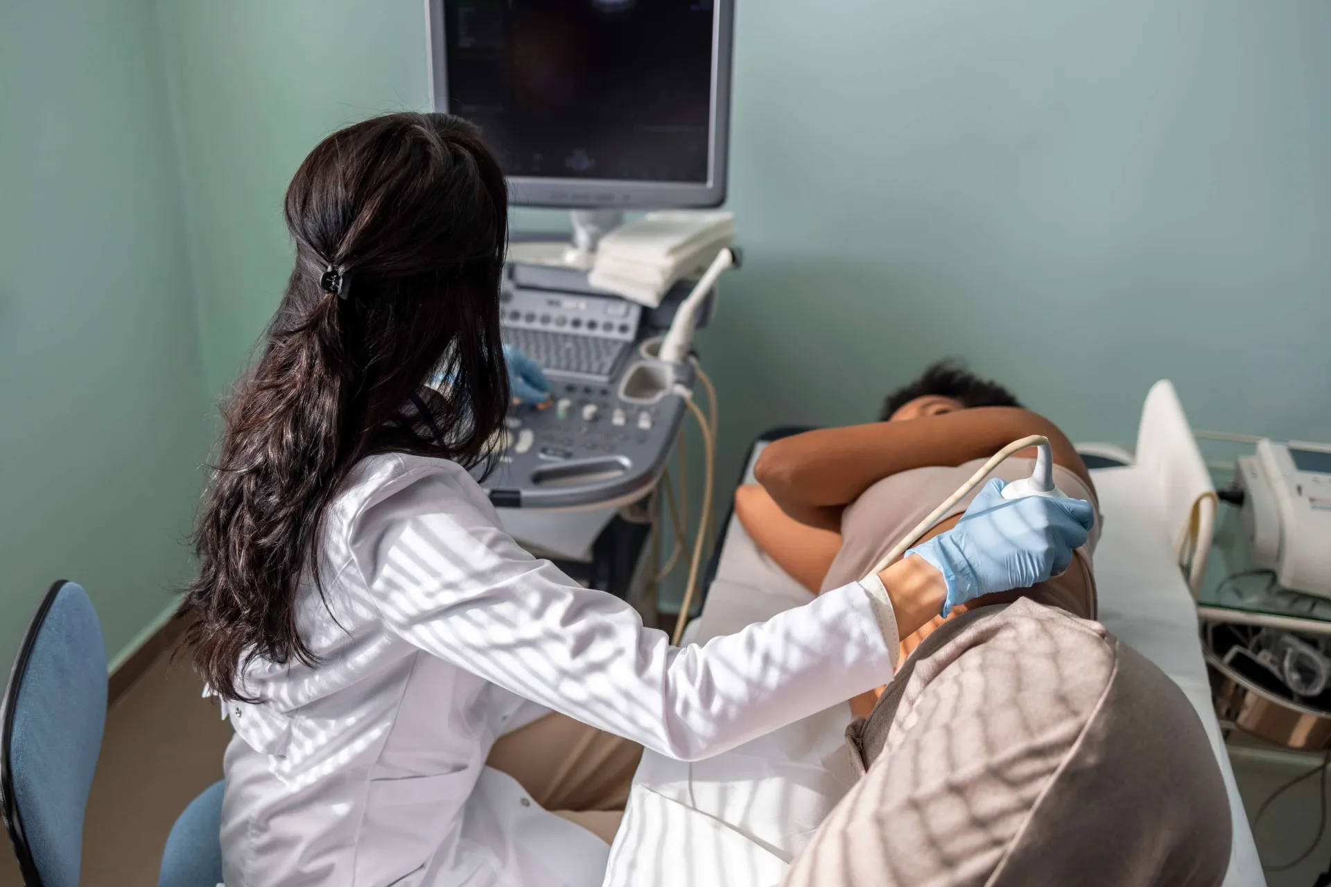 physician performing ultrasound on patient