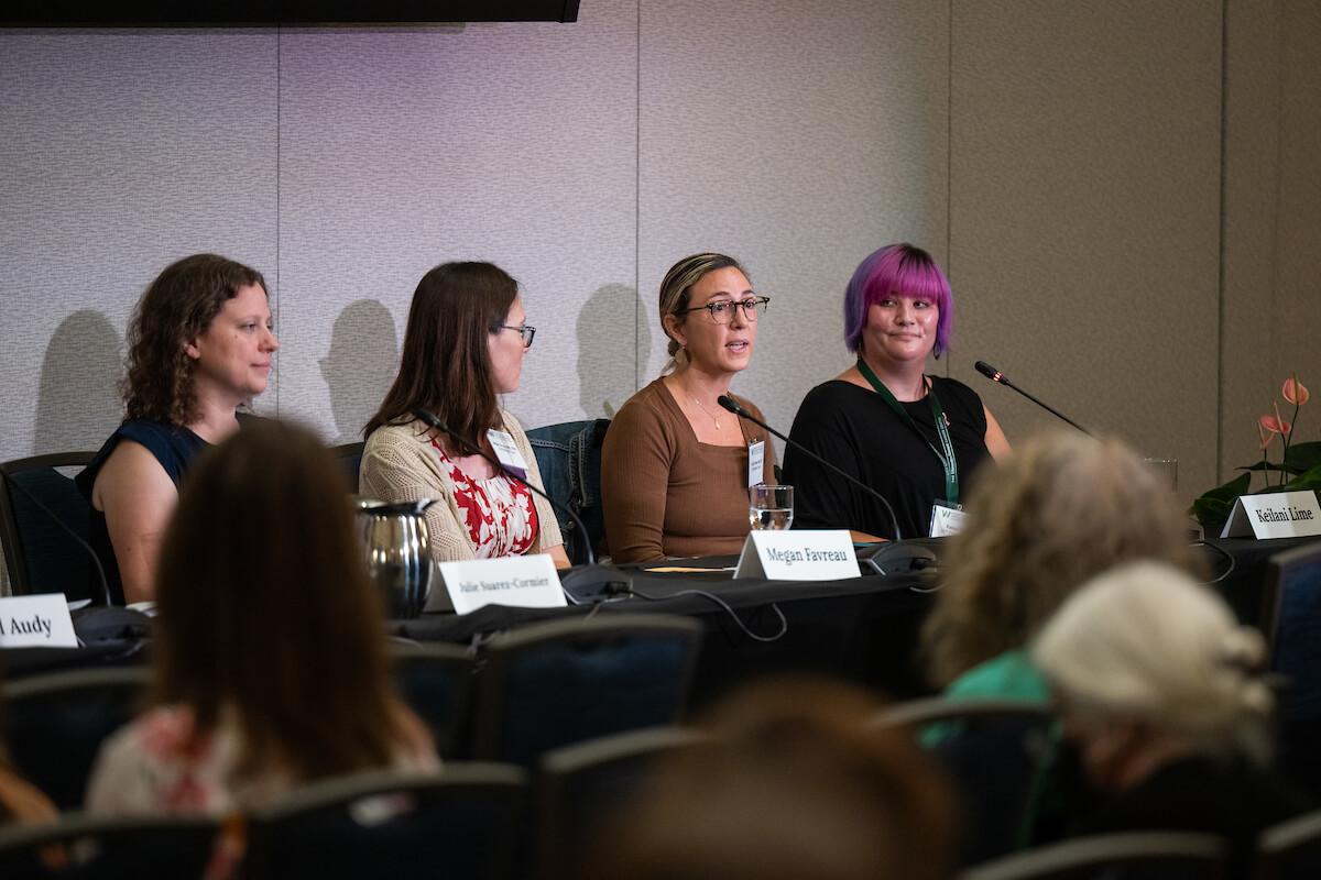 Four people speak on a panel