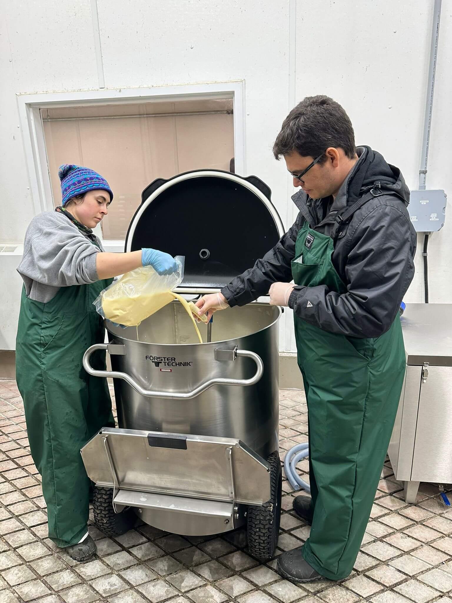 Two graduate students test milk