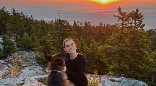 Student hiking with dog