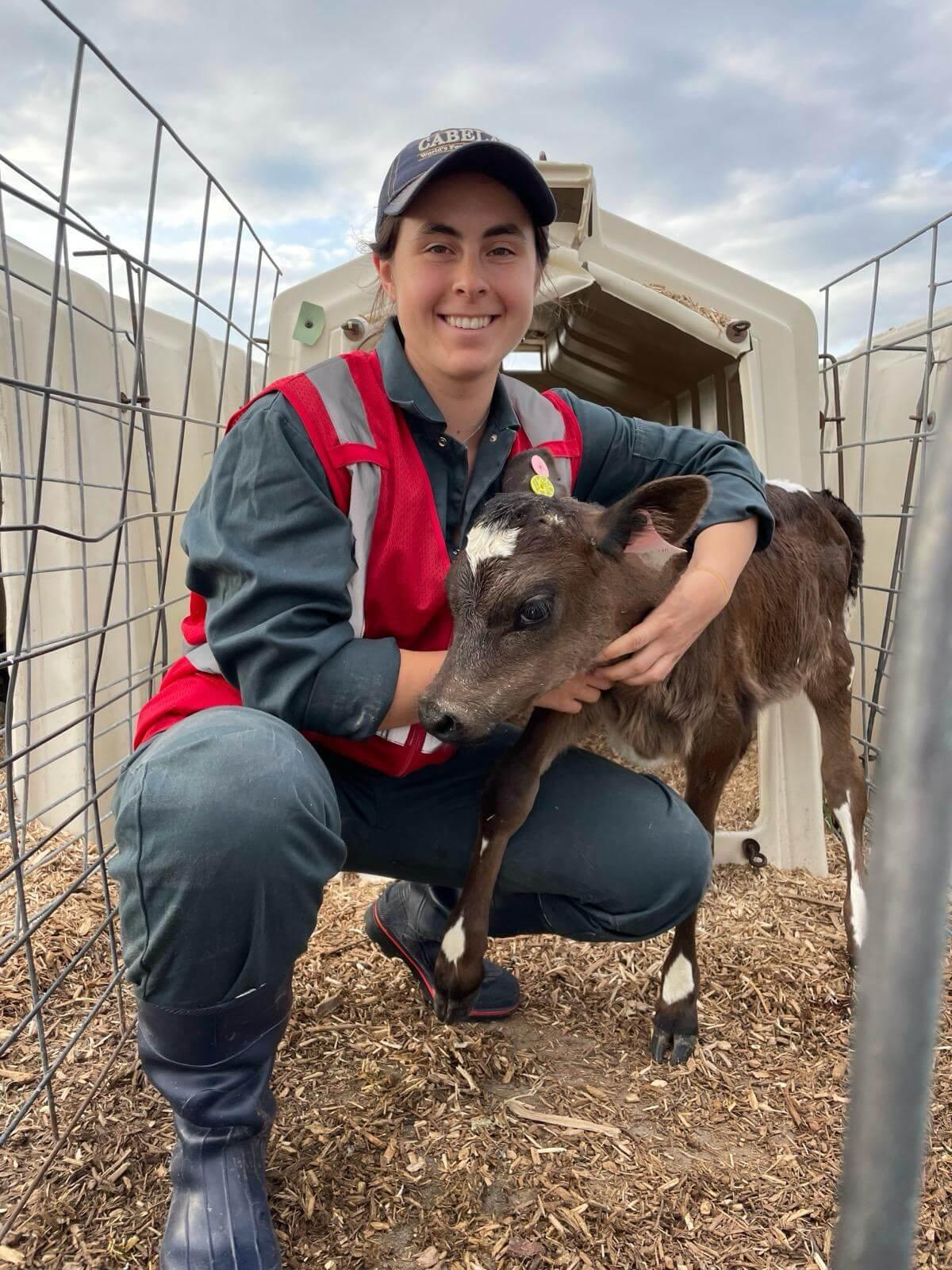 Graduate Student holds a calf
