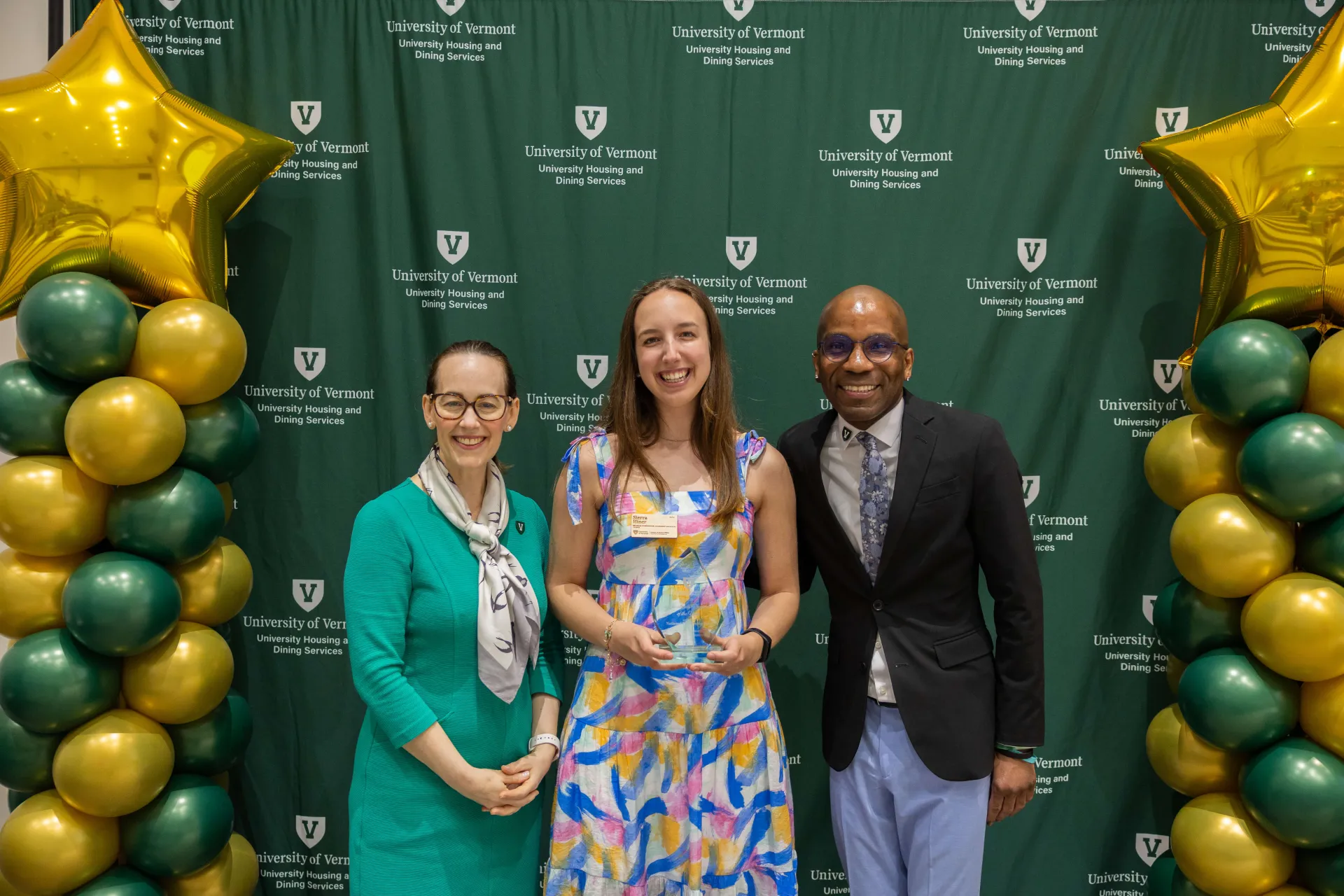 Staff taking picture with award