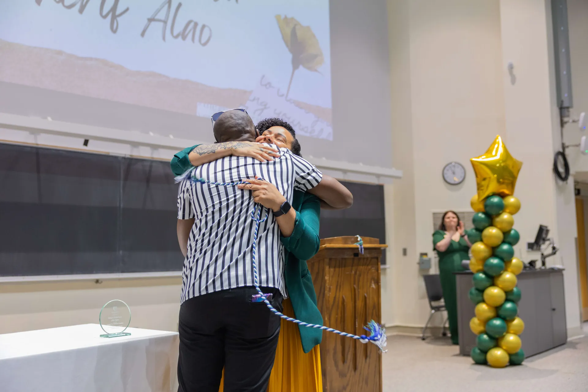 Staff being given cords for graduating 