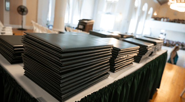 a stack of diplomas on a table