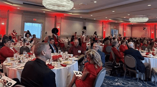 people at a banquet where many are wearing red