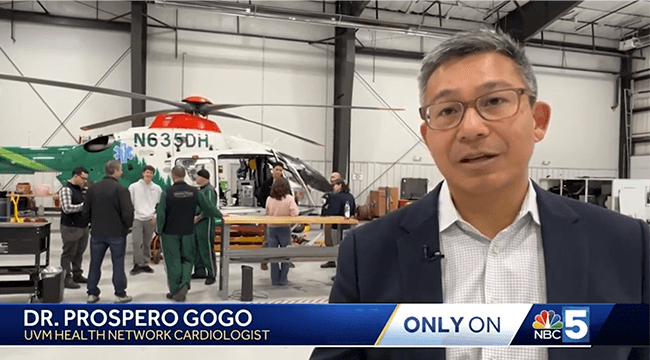 a man with people in a rescue helicopter hangar