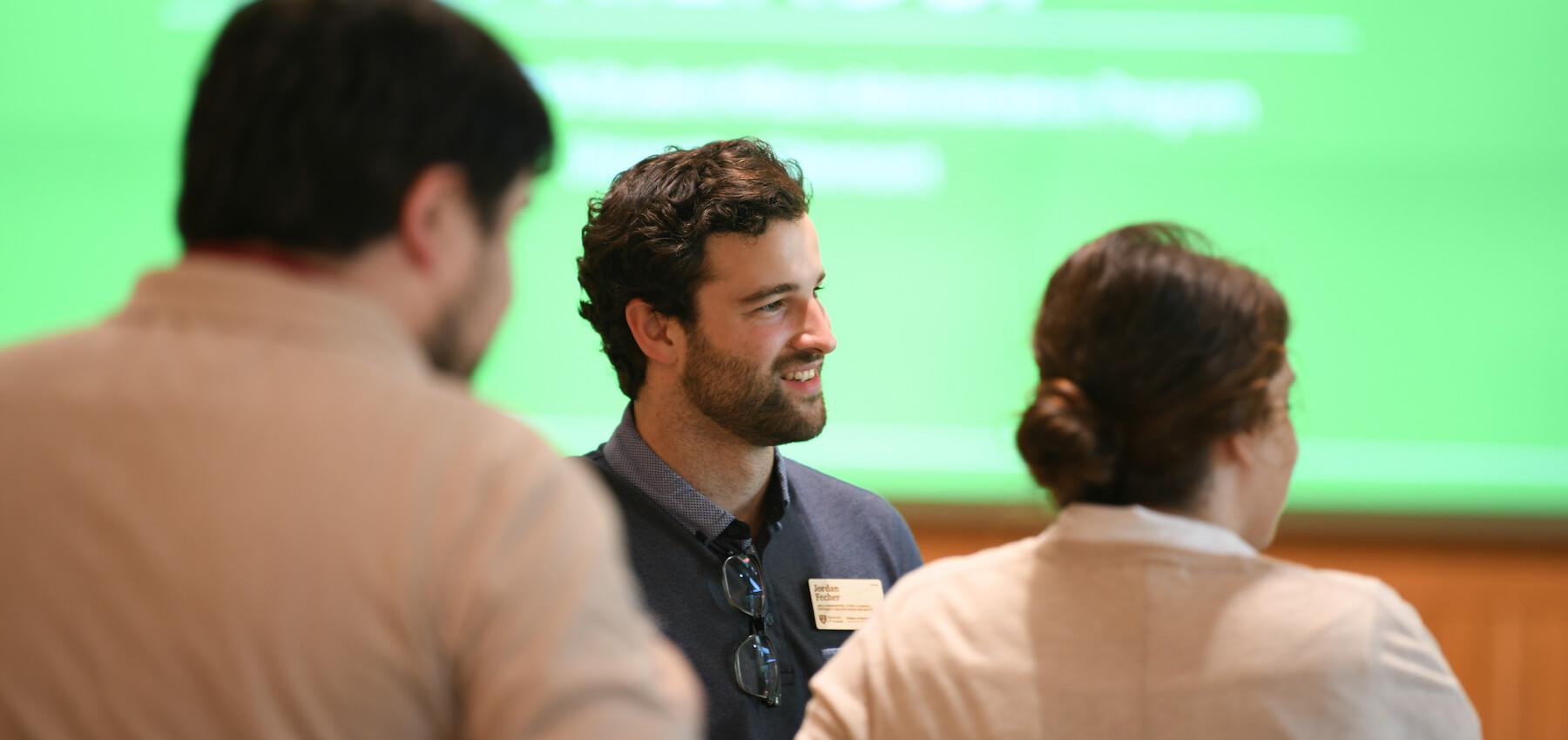 People talking at UVM HESA Reception event.