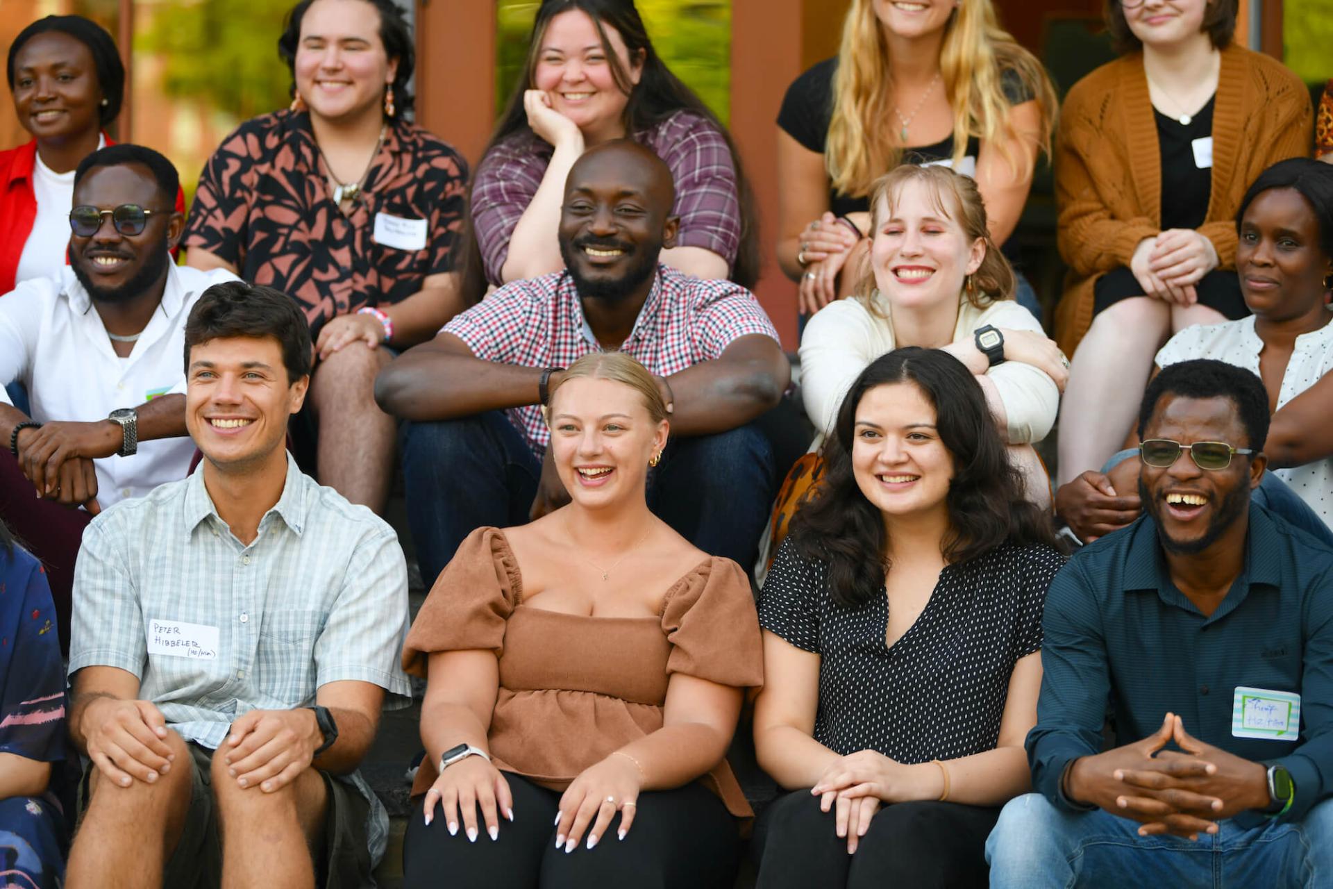 Group of HESA students smiling together at reception event.