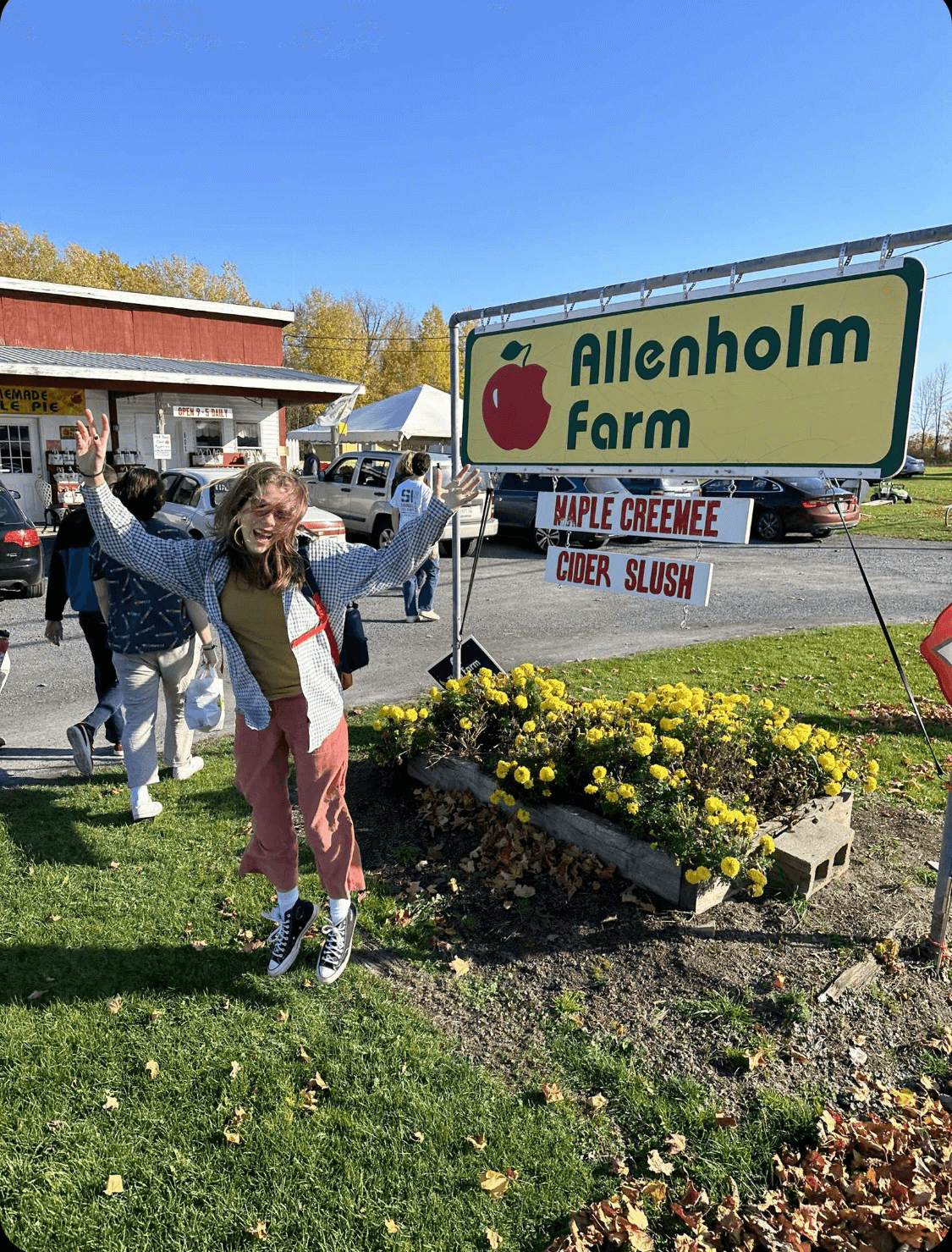 Student in front of a farmstand sign in Vermont