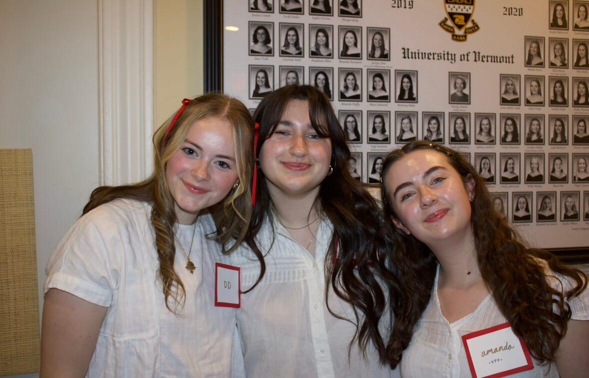 Three women pose at a philanthropy event