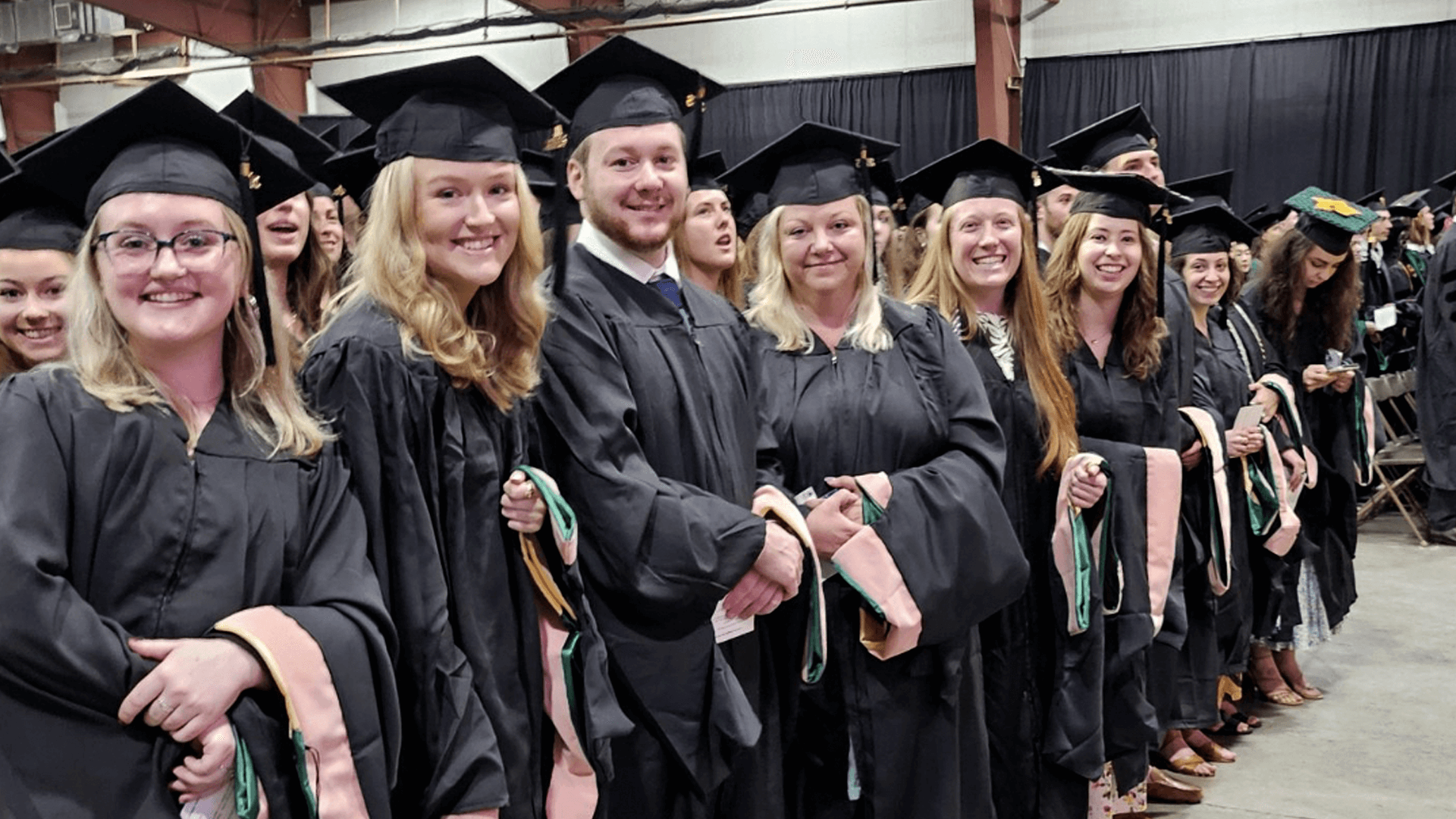 students in academic regalia at a graduation