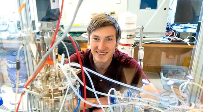 young man sitting at engineering workbench
