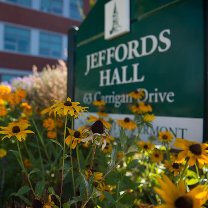 flowers around the sign for Jeffords Hall building