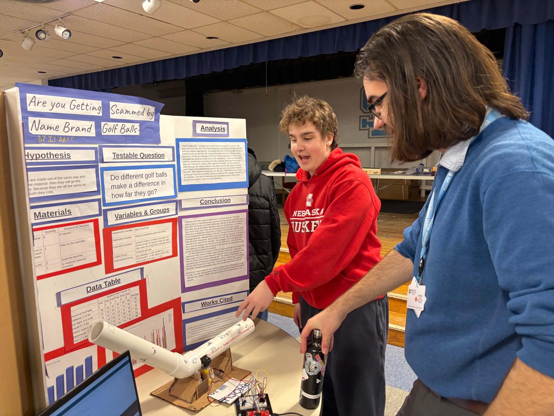Kevin Columbo with a student showcasing his work at Tuttle School Science Fair